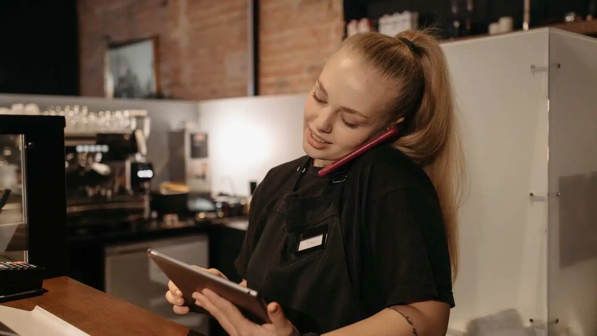 Une fille est au téléphone, elle manage la chaine d'approvisionnement et logistique d'une entreprise au sein d'un entrepôt